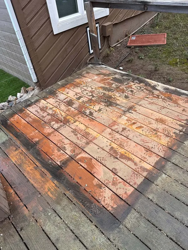The same deck after the hot tub was removed, showing the bare boards where it stood