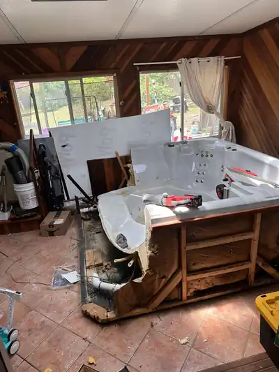 Hot tub being cut down and removed from a sun room