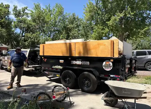 Rob beside the Bob's Round Up dump trailer on a residential driveway