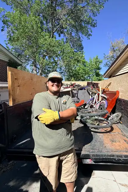 Rob from Bob's Round Up standing beside the loaded dump trailer on a job